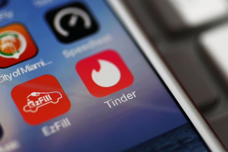 A photo illustration shows the Tinder app icon on a smartphone.