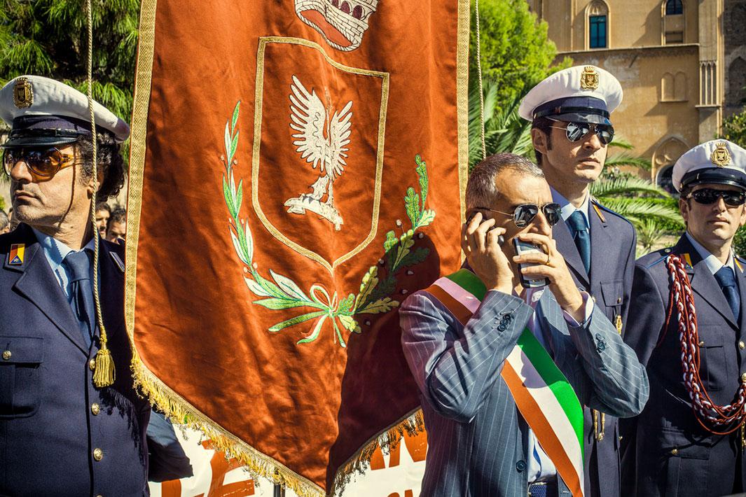 PALERMO, ITALY - OCTOBER 20, 2010: Corrado Valvo, Noto mayor, demonstrates in front of the City Council in Palermo to protest for the closing of Noto's hospital. He is surrounded by his city local police agents, who back him. In Italy It is not unusual to see politicians leading demonstrations wearing full dress uniform. The man speaking with two mobile phones while covering his mouth, and the gang looks are misleading: they are not the evil ones in this situation.