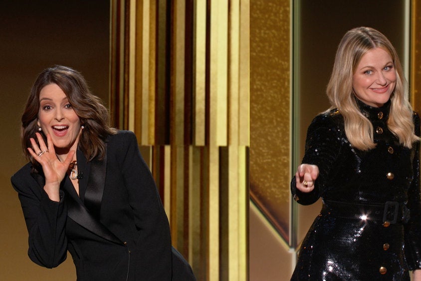 Tina Fey and Amy Poehler joke with each other at the Golden Globe Awards.