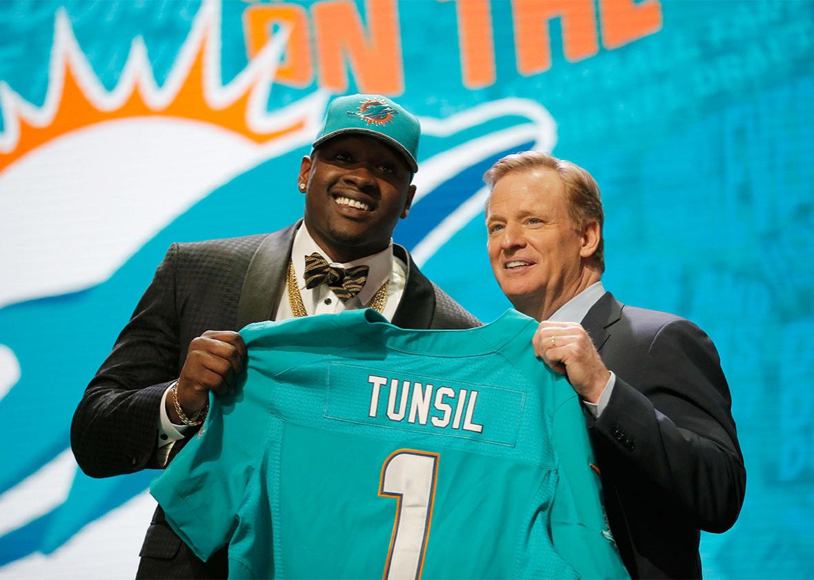 Laremy Tunsil of Ole Miss holds up a jersey with NFL Commissioner Roger Goodell after being picked #13 overall by the Miami Dolphins during the first round of the 2016 NFL Draft at the Auditorium Theatre of Roosevelt University on April 28, 2016 in Chicago, Illinois. 