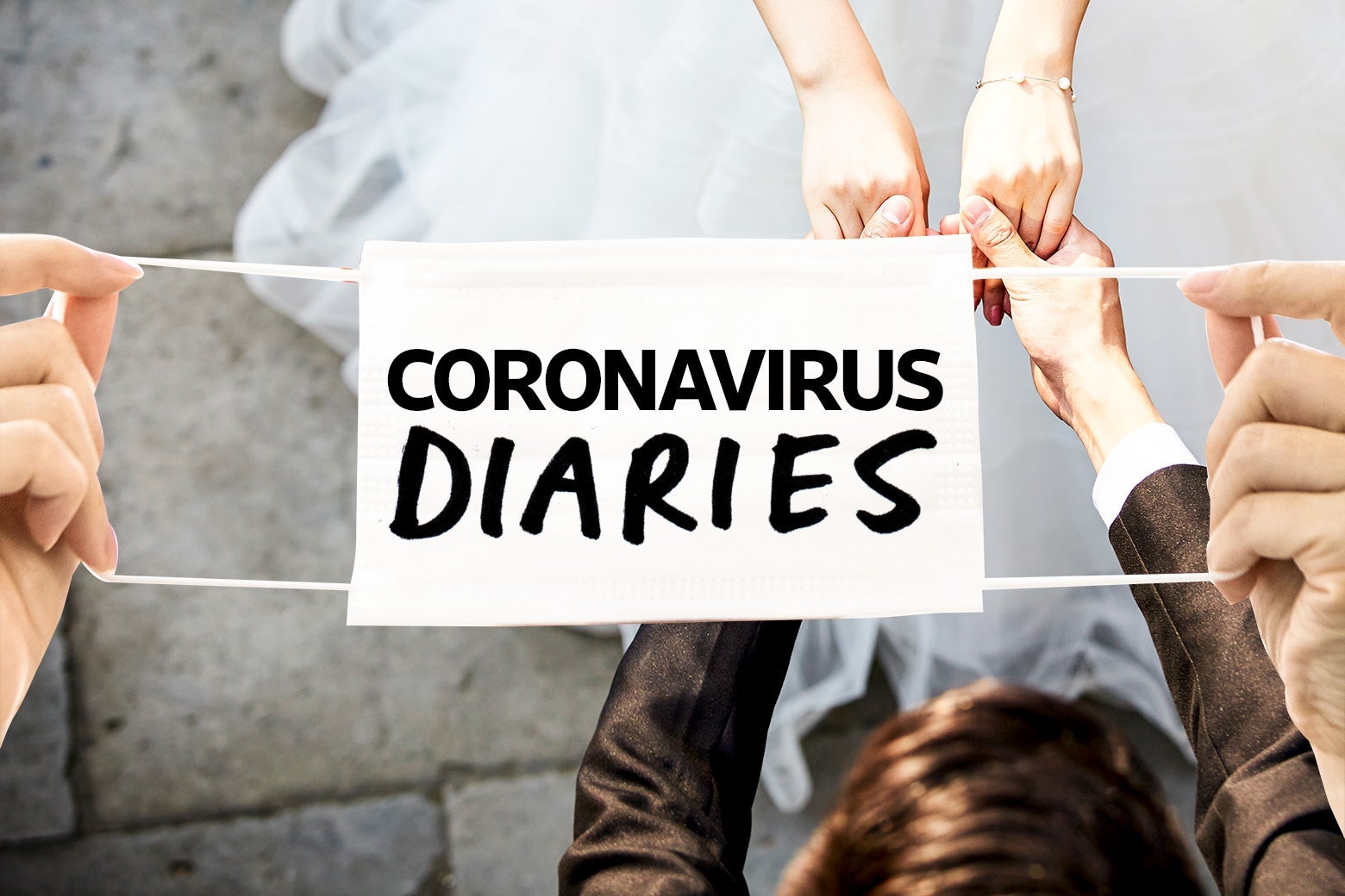 A view from above of two newlyweds holding hands, with a mask with the words "Coronavirus Diaries" draped over the setting