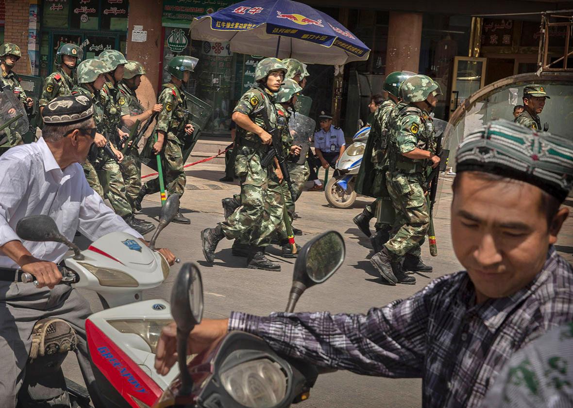 Chinese soldiers march past near the Id Kah Mosque, China's larg