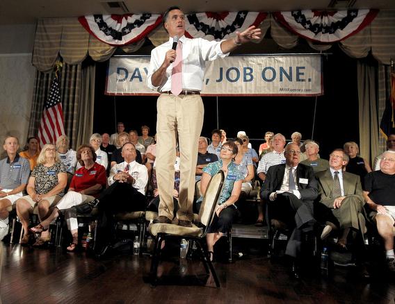  Mitt Romney stands on chairin Sun Lakes, Ariz.