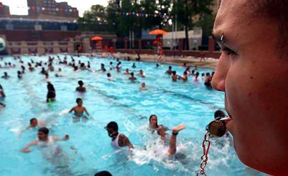 Lifeguard Dennis Rodriguez, 17, keeps on eye on swimmers June 28, 2002 on the opening day of New York City's public pools.