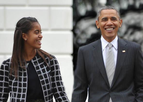 President Obama walks with daughter Malia on October 27, 2013 in Washington, DC.