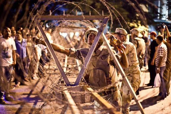 Egyptian army soldiers take out barbed wire that was surrounding the Supreme Constitutional Court in Cairo.