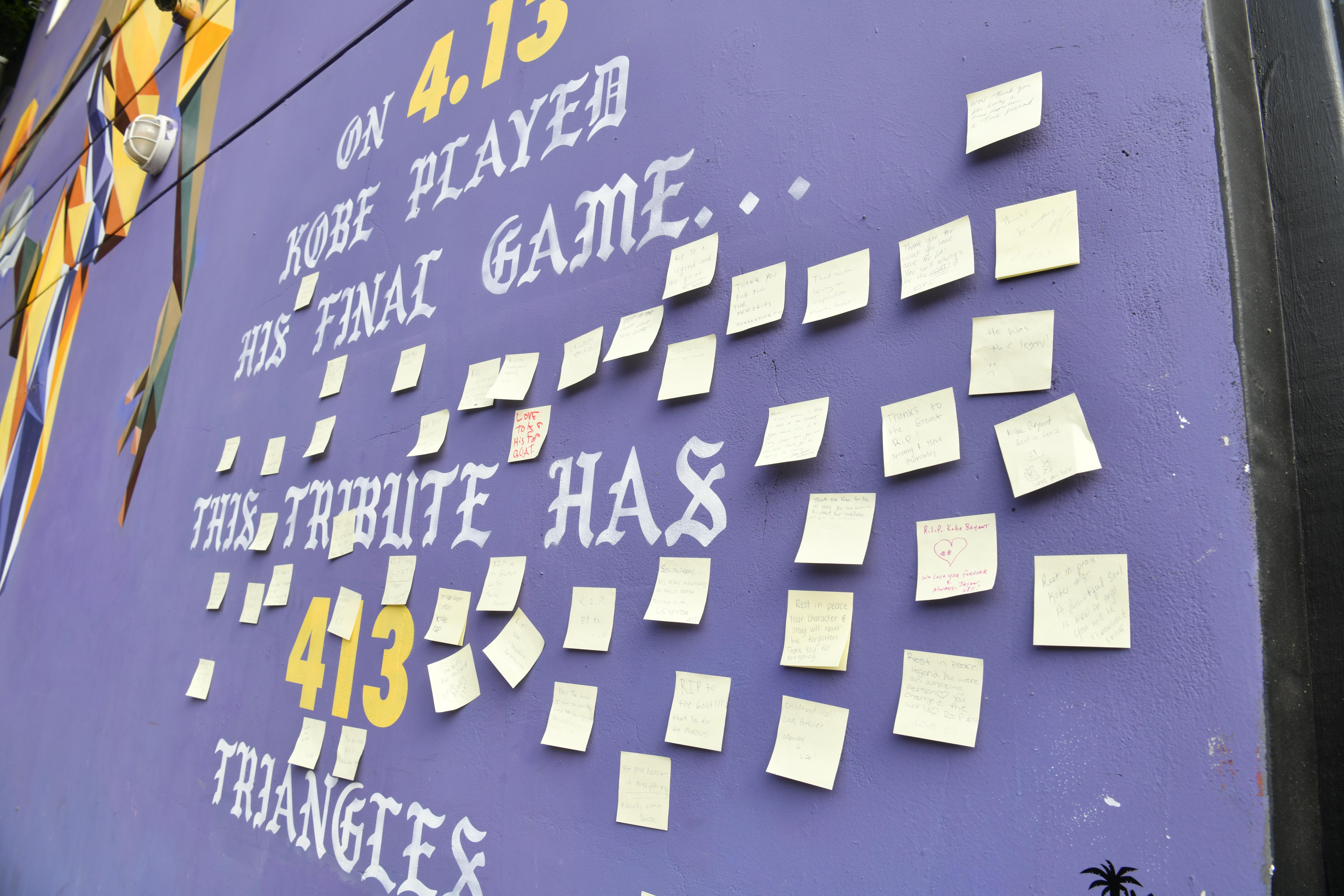A Los Angeles wall mural depicting Kobe in his Lakers uniform, covered with post-its with notes from mourners.