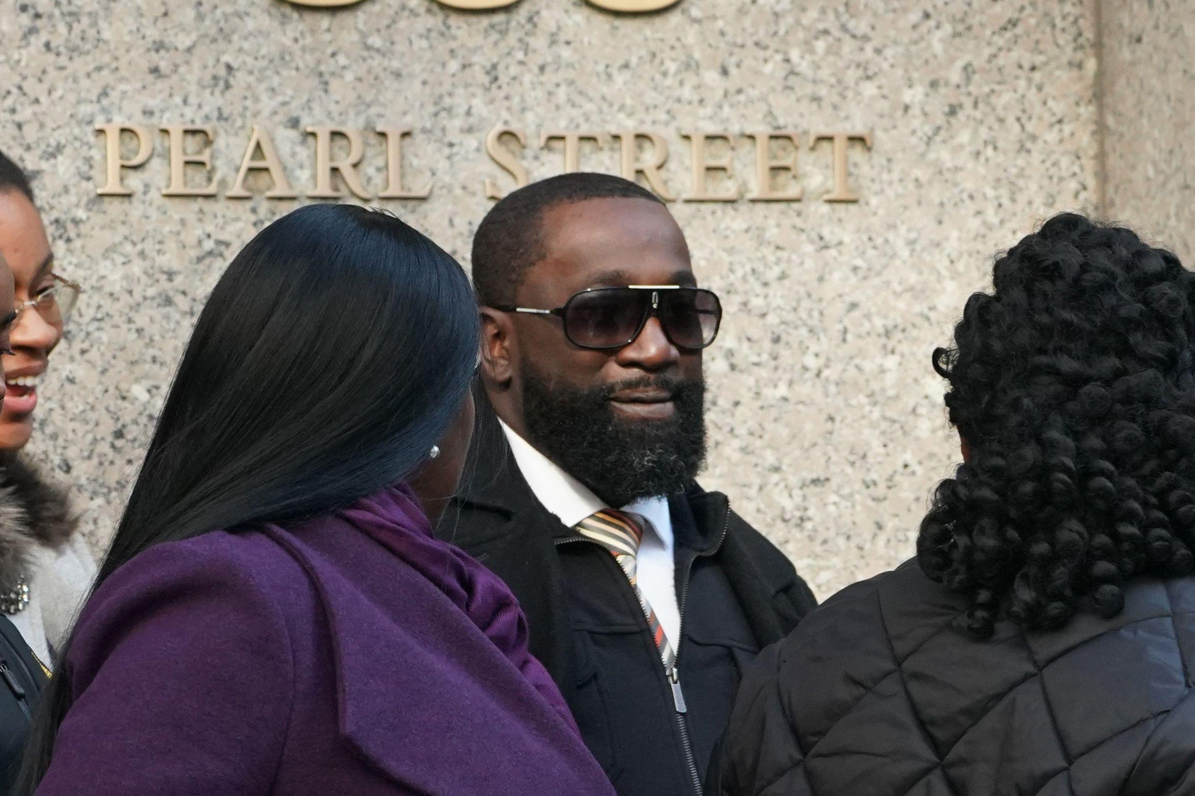Metropolitan Correctional Center guard Michael Thomas (C) surrounded by supporters leaves Federal Court in New York City on November 25, 2019. 