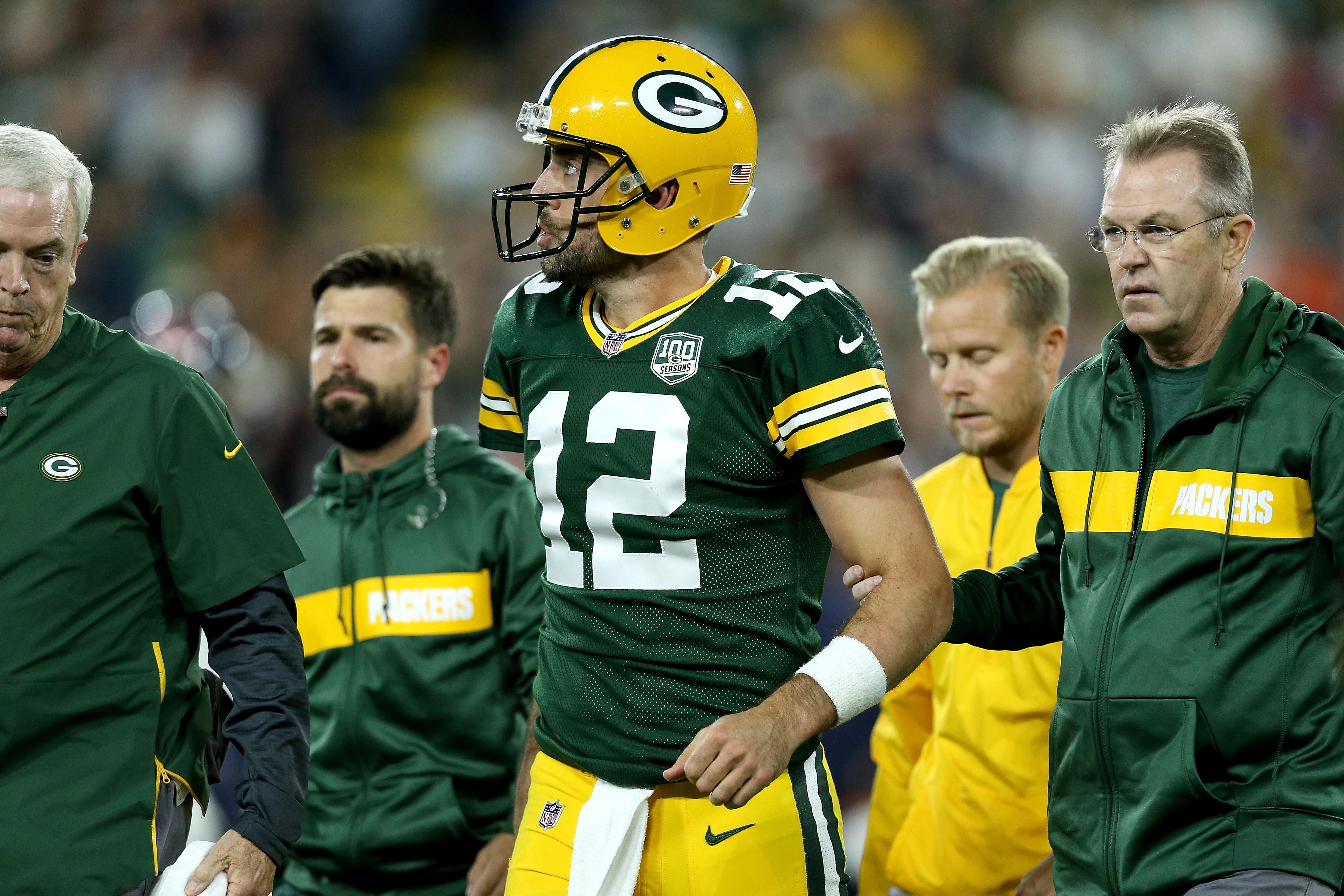 GREEN BAY, WI - SEPTEMBER 09:  Aaron Rodgers #12 of the Green Bay Packers is helped off the field after injuring his leg in the second quarter of a game against the Chicago Bears at Lambeau Field on September 9, 2018 in Green Bay, Wisconsin.  (Photo by Dylan Buell/Getty Images)