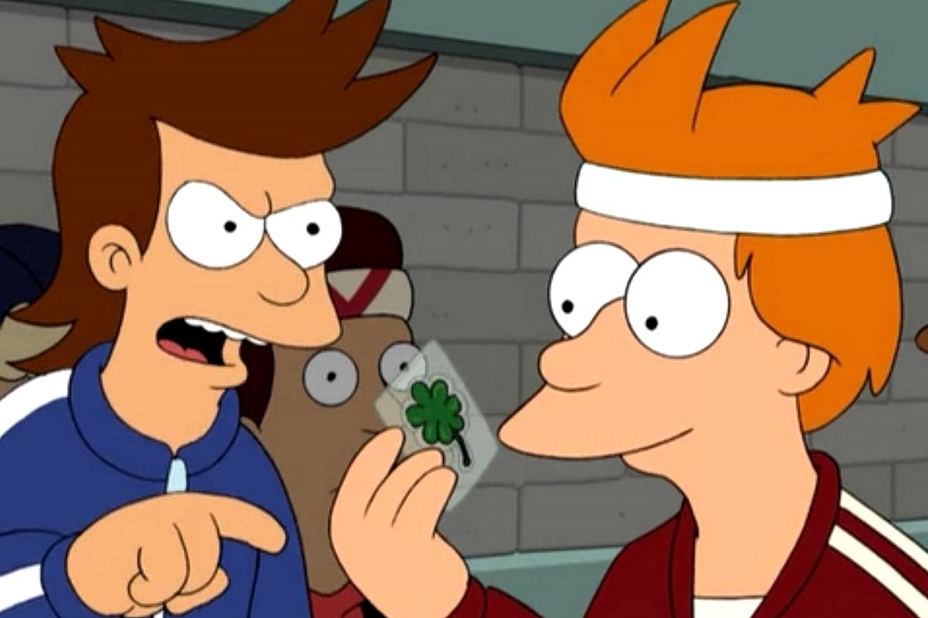 Fry admires a four-leaf clover while another person in a tracksuit points at him intensely.