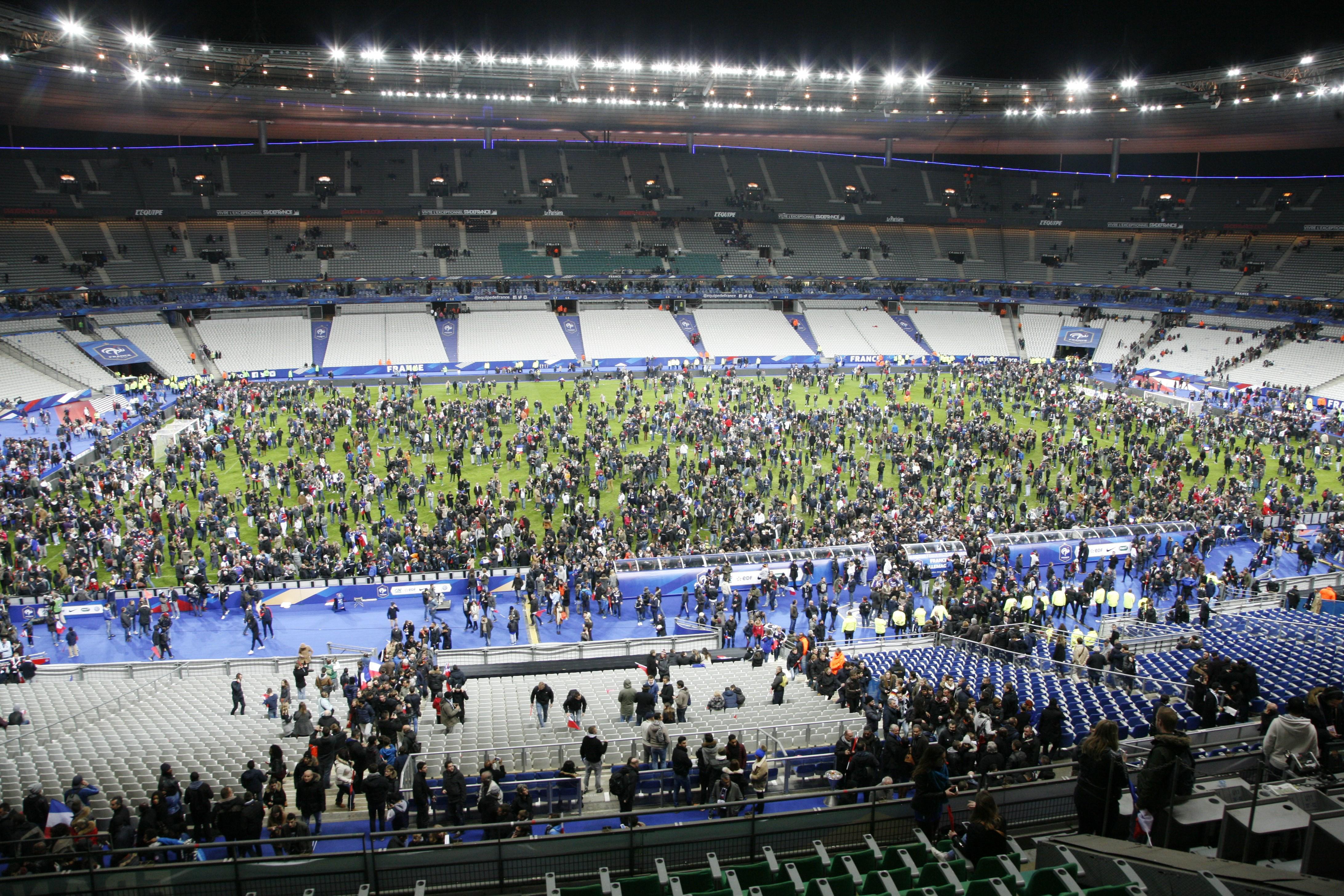 Spectators waited on the field of France’s national stadium, the Stade de France