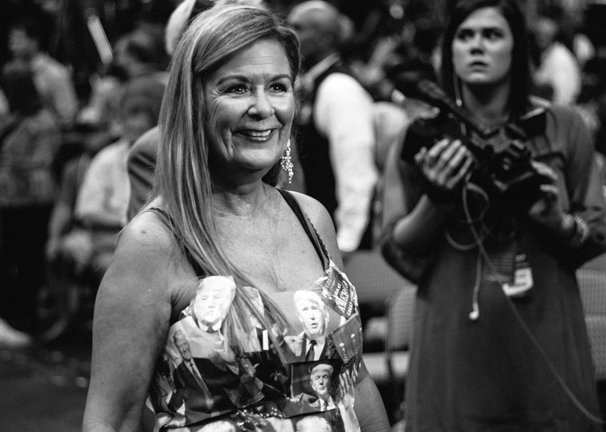 A woman poses for a news camera with her Donald Trump-themed dre