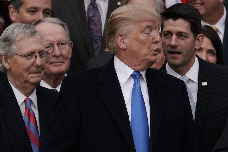 WASHINGTON, DC - DECEMBER 20:  U.S. Speaker of the House Rep. Paul Ryan (R-WI) talks to President Donald Trump (3rd L) as Senate Majority Leader Sen. Mitch McConnell (R-KY), and Sen. Lamar Alexander (R-TN) (2nd L) look on during an event to celebrate Congress passing the Tax Cuts and Jobs Act with Republican members of the House and Senate on the South Lawn of the White House December 20, 2017 in Washington, DC. The tax bill is the first major legislative victory for the GOP-controlled Congress and Trump since he took office almost one year ago.  (Photo by Alex Wong/Getty Images)