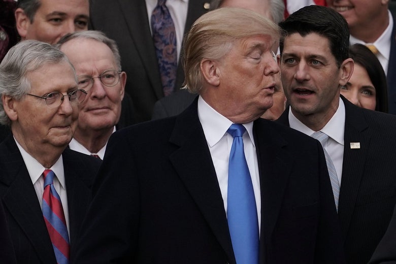 WASHINGTON, DC - DECEMBER 20: U.S. Speaker of the House Rep. Paul Ryan (R-WI) talks to President Donald Trump (3rd L) as Senate Majority Leader Sen. Mitch McConnell (R-KY), and Sen. Lamar Alexander (R-TN) (2nd L) look on during an event to celebrate Congress passing the Tax Cuts and Jobs Act with Republican members of the House and Senate on the South Lawn of the White House December 20, 2017 in Washington, DC. The tax bill is the first major legislative victory for the GOP-controlled Congress and Trump since he took office almost one year ago. (Photo by Alex Wong/Getty Images)