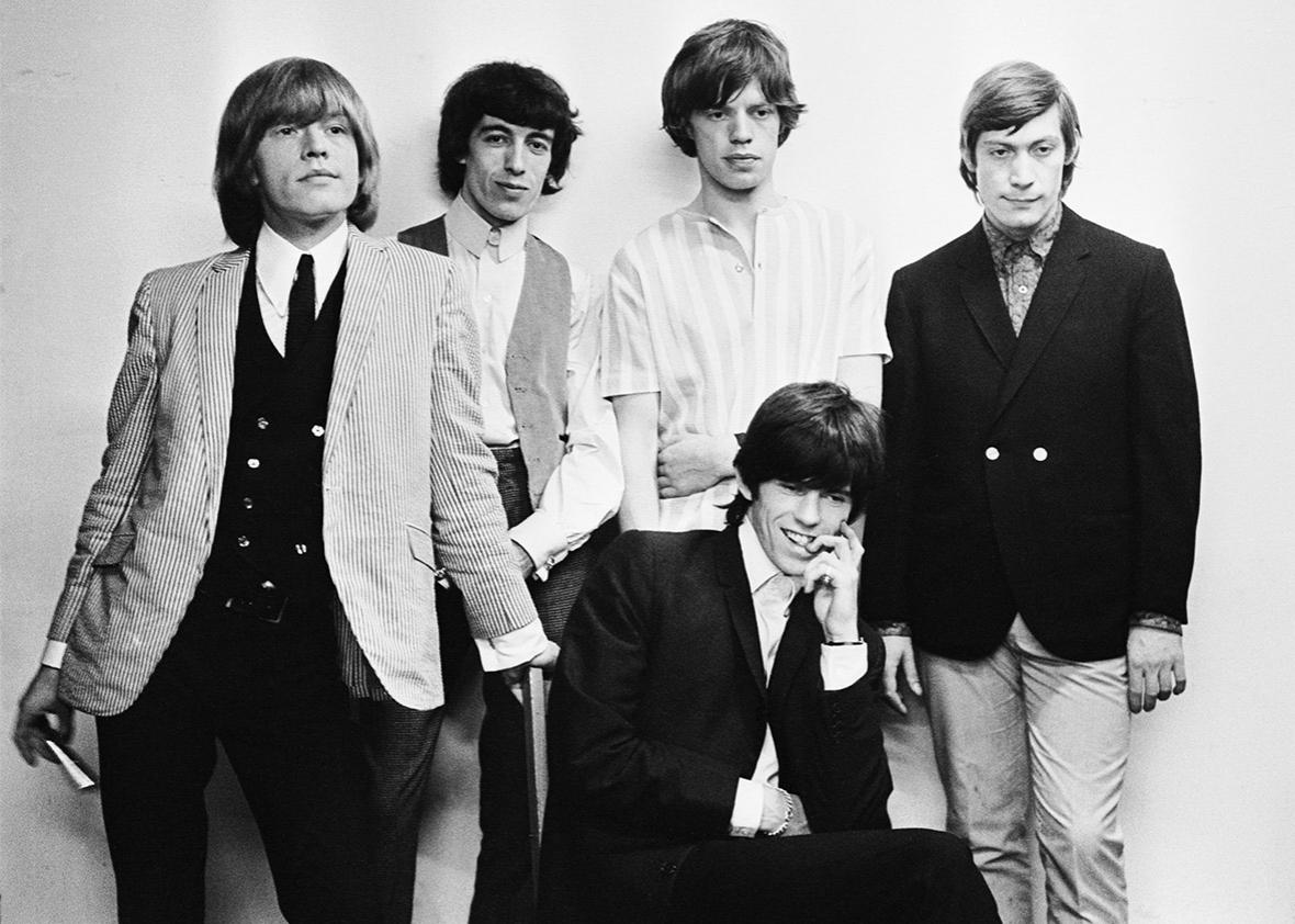 From left to right, Brian Jones (1942 - 1969), Bill Wyman, Mick Jagger and Charlie Watts, and (seated) Keith Richards of the Rolling Stones, circa 1965. 