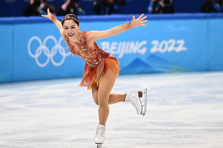 Higuchi spreading her arms and smiling on the ice during her routine