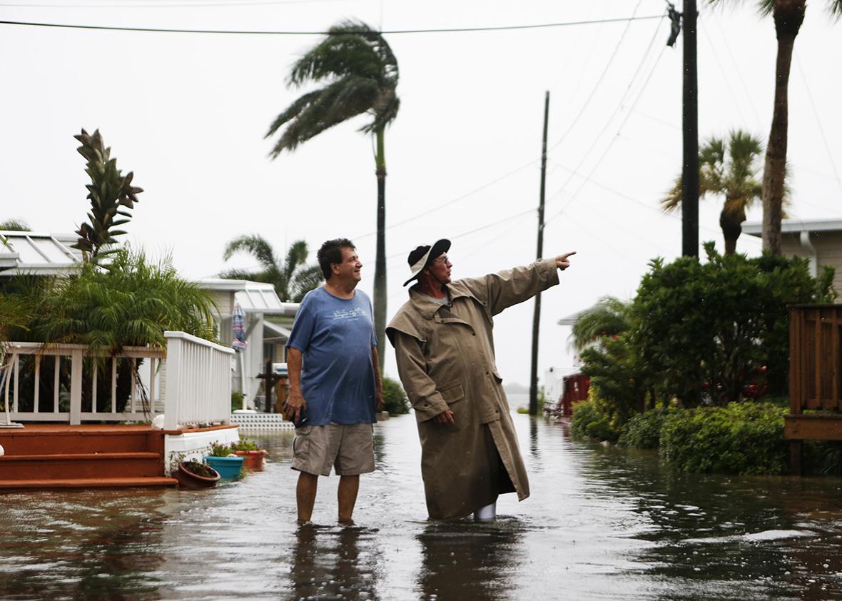 Residents of the Sandpiper Resort survey the rising water coming from the Gulf of Mexico into their neighborhood as winds and storm surge associated with Tropical Storm Hermine impact the area on September 1, 2016 at in Holmes Beach, Florida.