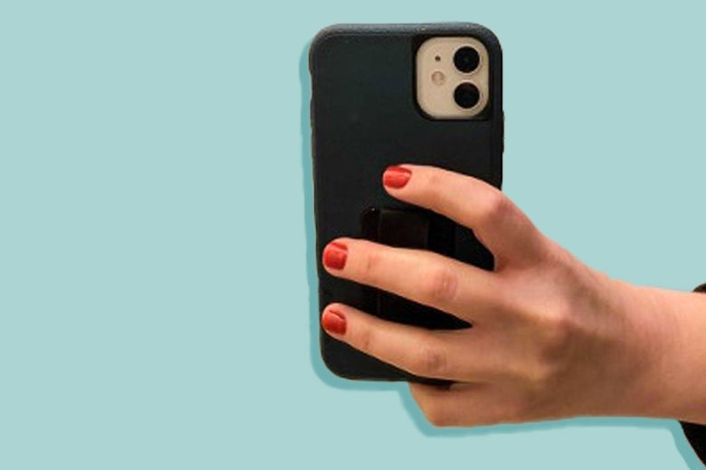 A hand with red nails holding a phone such that it rests on the pinkie finger curled under it