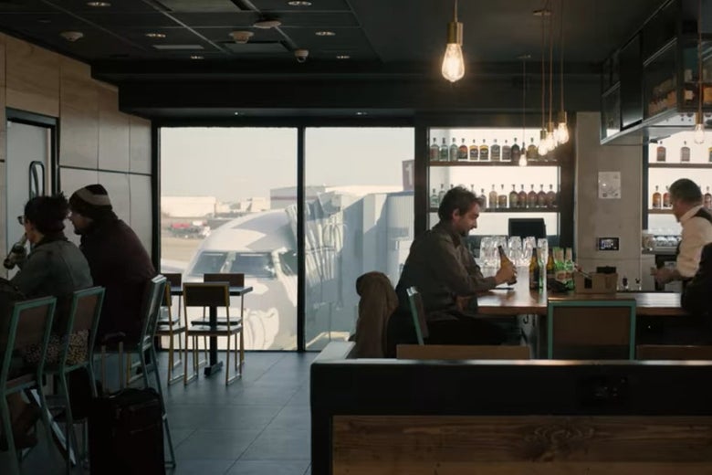 Bill drinks at an airport bar.