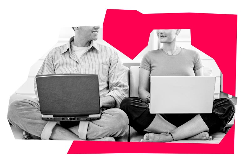 A woman and a man look at each other while sitting side by side and using laptops.