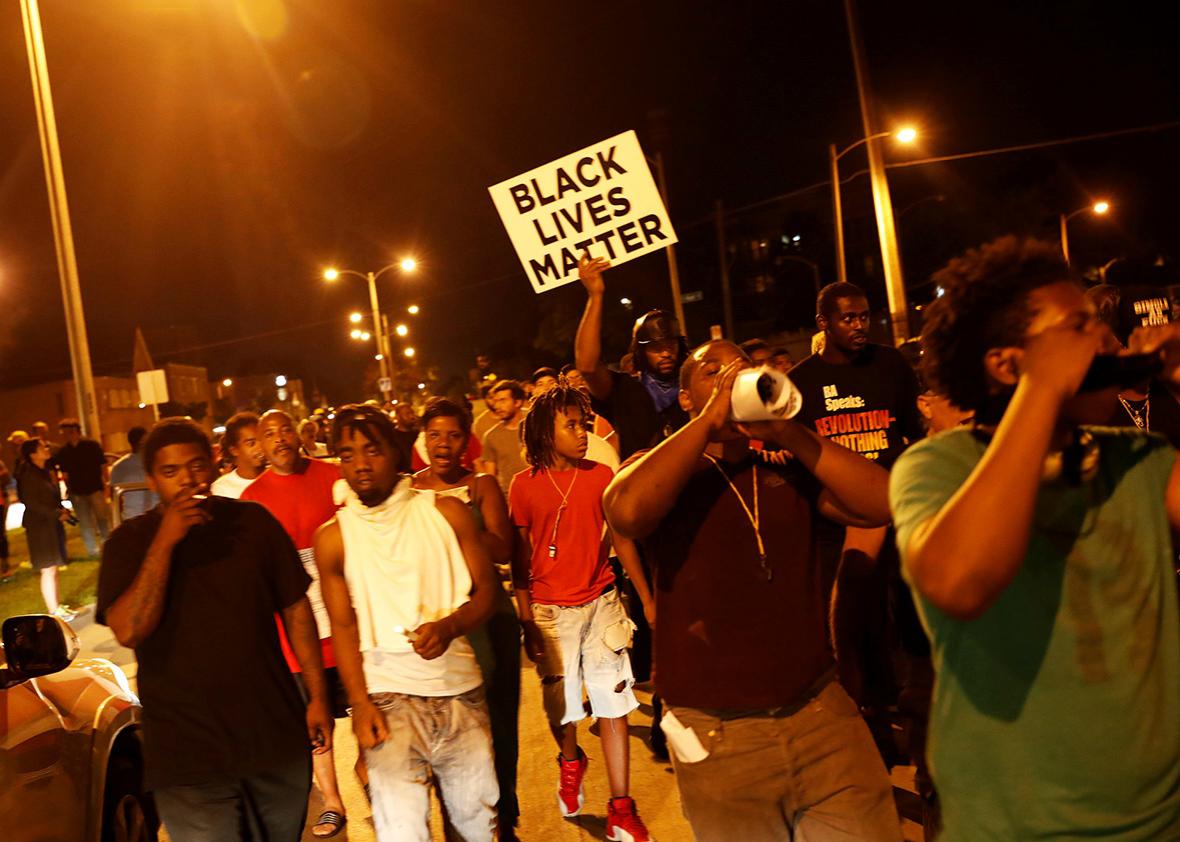 Protestors march during disturbances following the police shooting of a man in Milwaukee, Wisconsin, U.S. August 14, 2016. 
