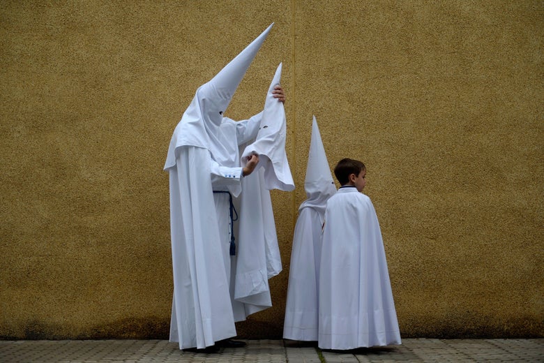 I mean, it just looks like a Klan member with some little Klan members. White pointy hats, robes, the whole thing.