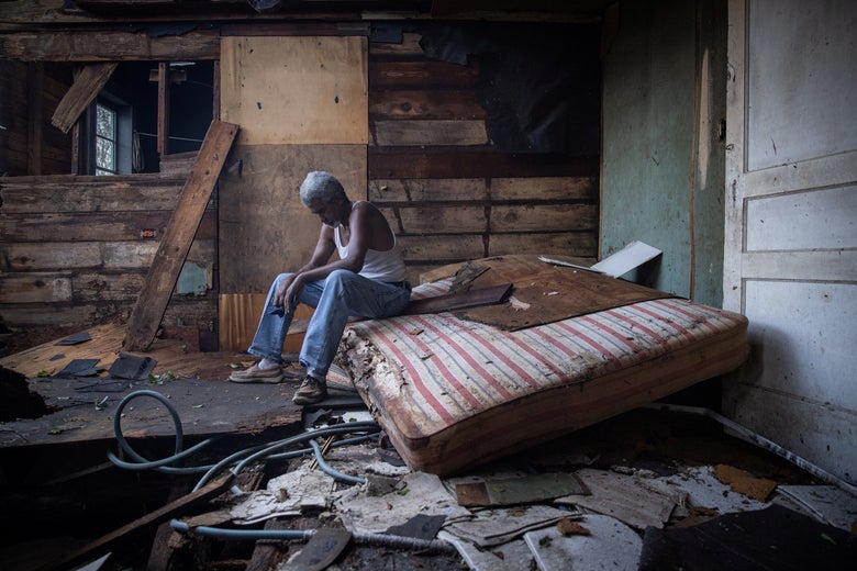 Theophilus Charles, 70, sits inside his house which was heavily damaged by Hurricane Ida in Houma, Louisiana, August 30, 2021.