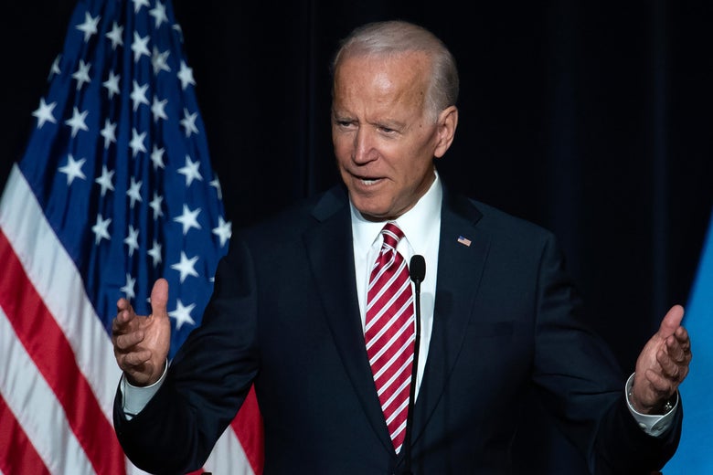 Joe Biden speaks while standing on a stage at a political event.
