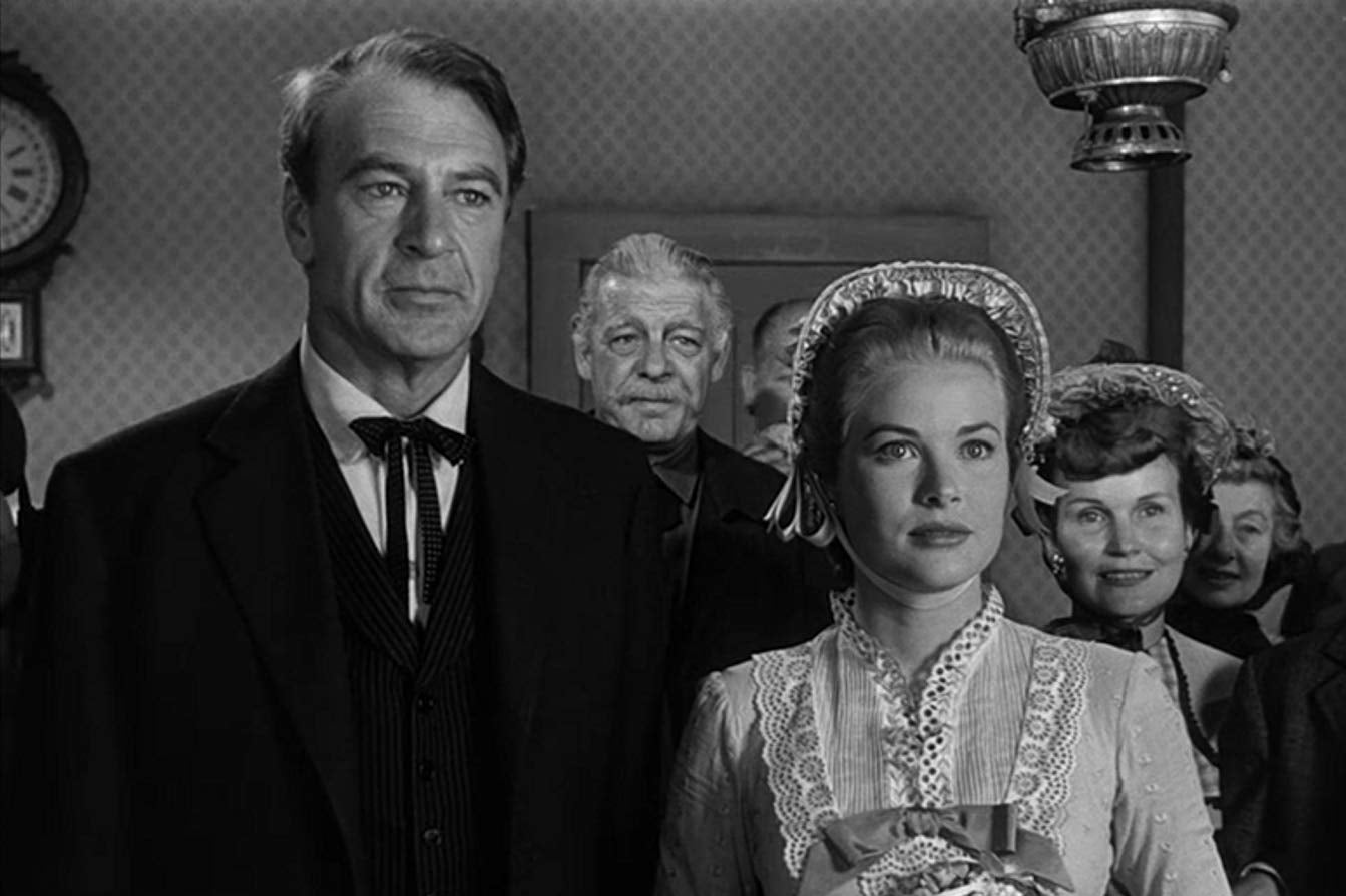 Gary Cooper and Grace Kelly, who wears a bonnet and holds a bouquet