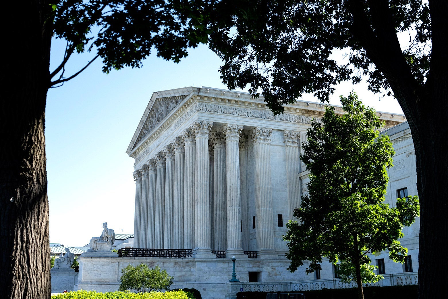 The Supreme Court is seen through some trees.