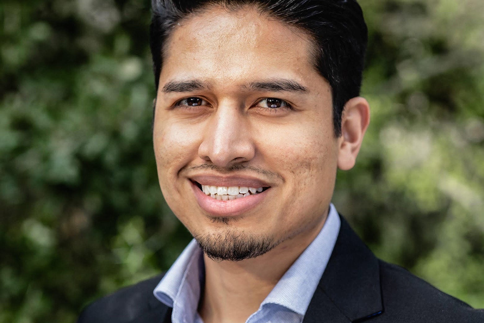 A professional headshot of Calderon.