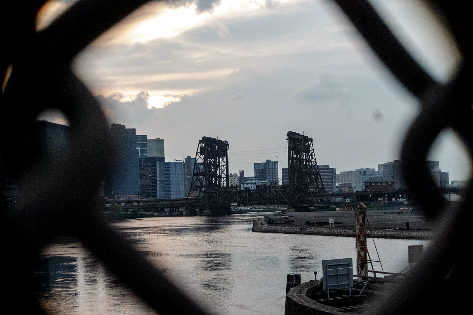 A power plant is seen through a fence.