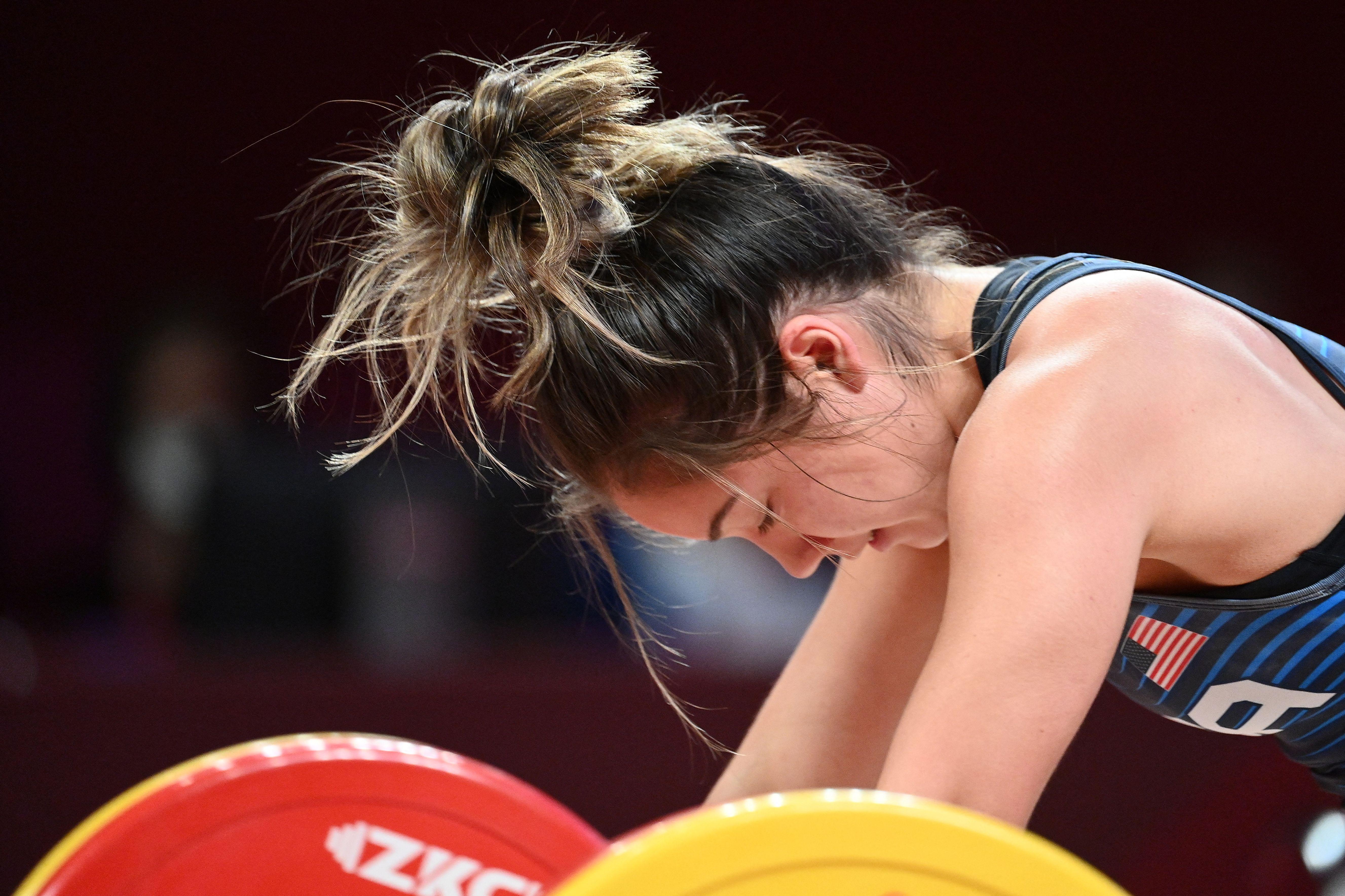 Jourdan Elizabeth Delacruz reacts as she competes in the women's 49kg weightlifting competition during the Tokyo 2020 Olympic Games at the Tokyo International Forum in Tokyo on July 24, 2021. 