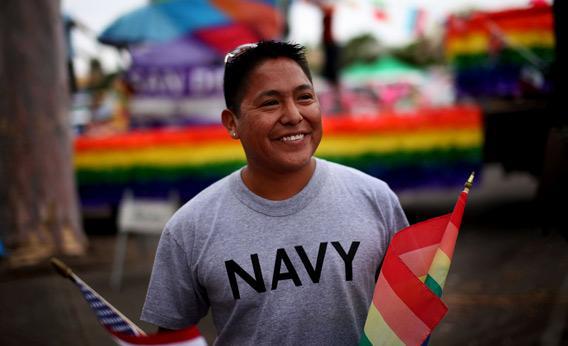 Joseph Martinez, an active duty sailor in the Navy, parepares to march in a gay pride parade.
