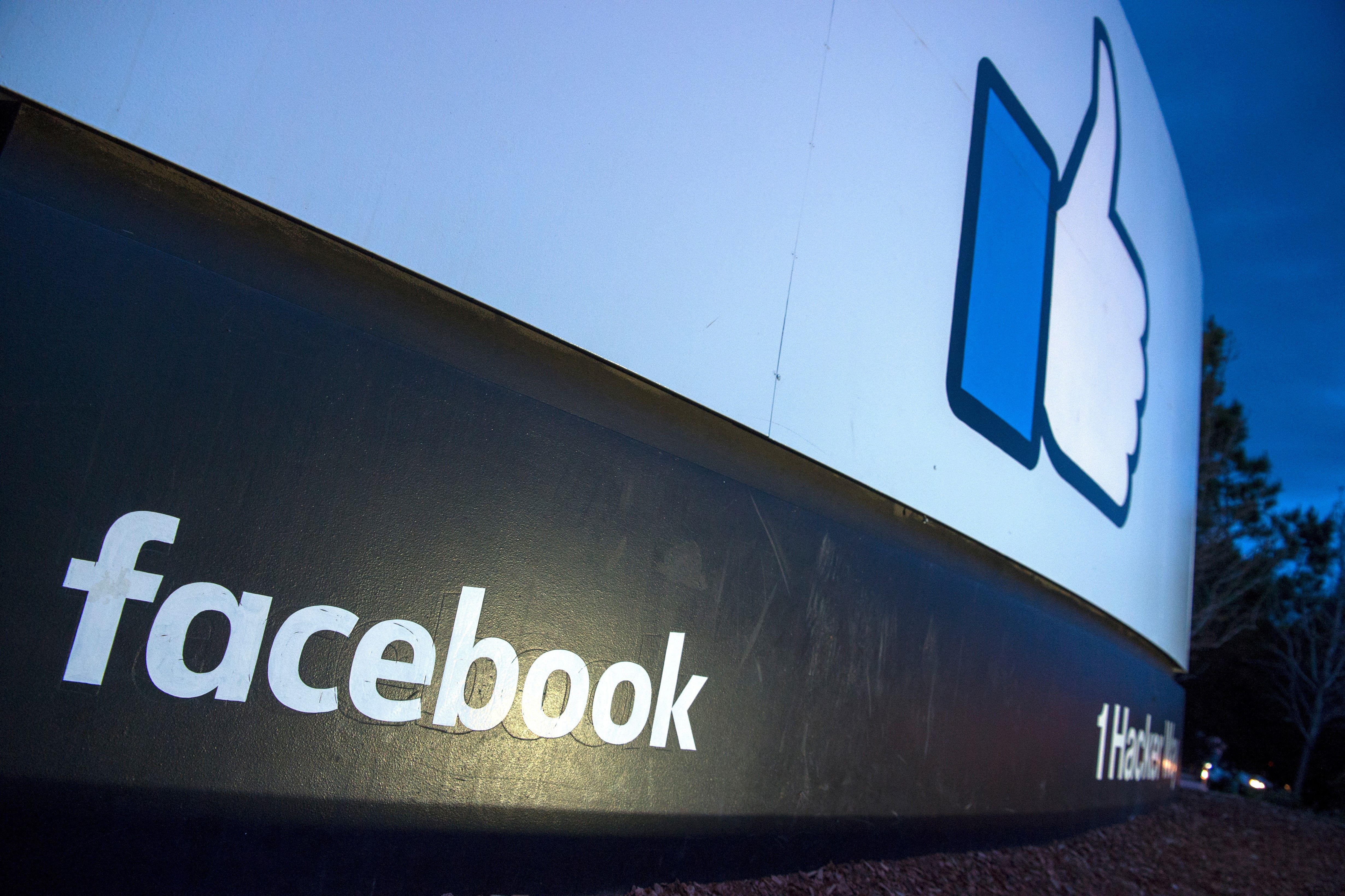 A sign featuring the like thumbs-up icon at the entrance to Facebook's corporate headquarters.