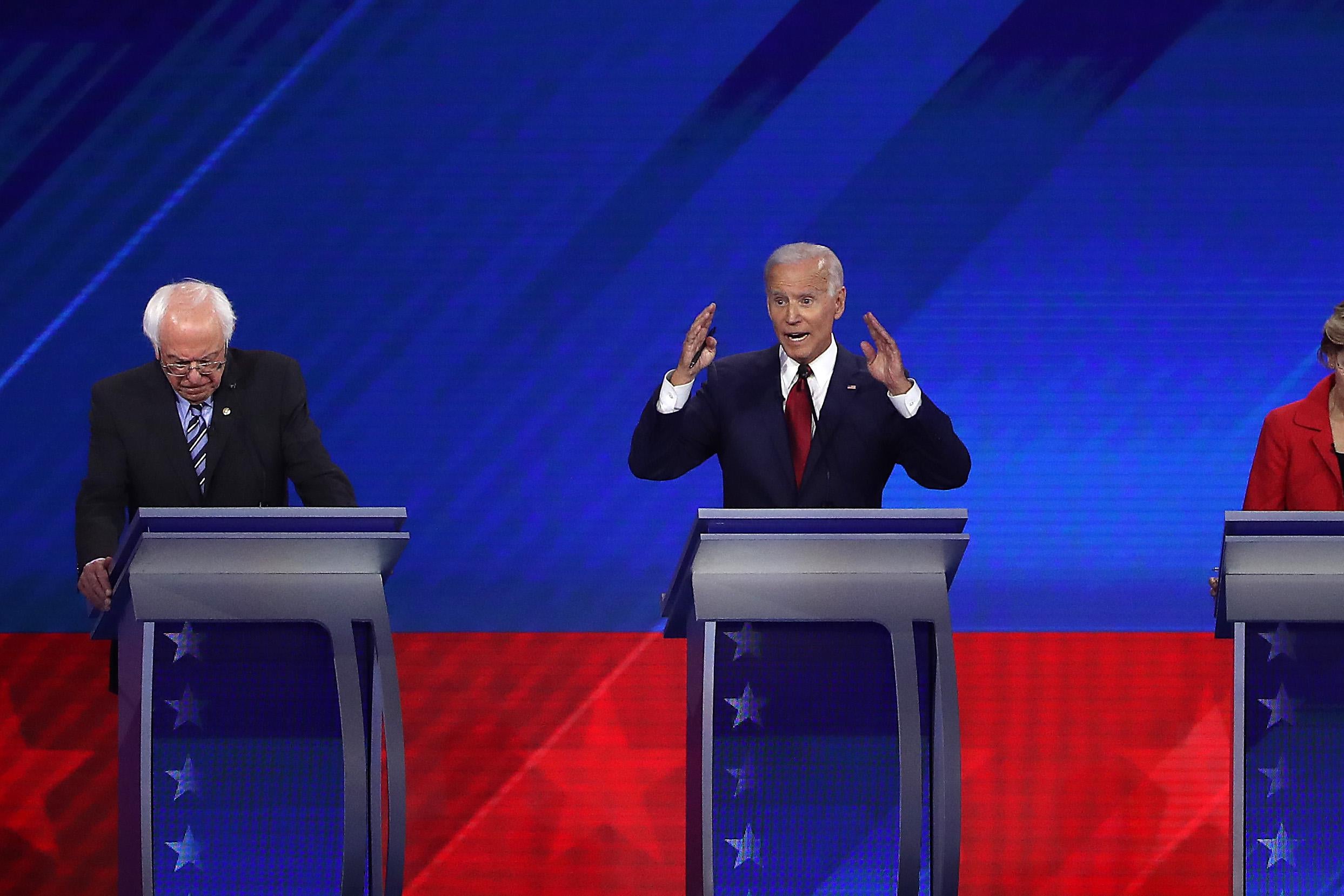 Bernie Sanders, Joe Biden, and Elizabeth Warren at their podiums.