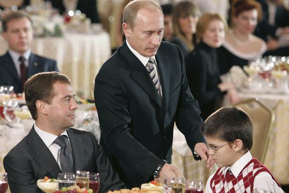 Russia's First Deputy Prime Minister Dmitry Medvedev (left) and President Vladimir Putin (center) attend the opening ceremony of the Year of the Family in Moscow's Kremlin, Dec. 24, 2007.