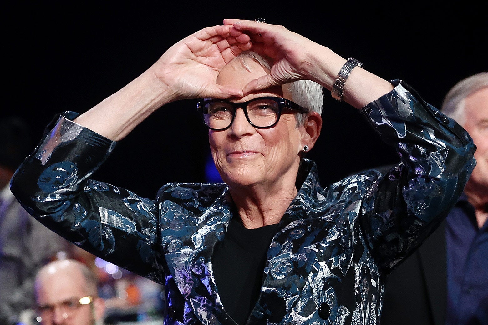 Jamie Lee Curtis holds her hands up on her forehead.