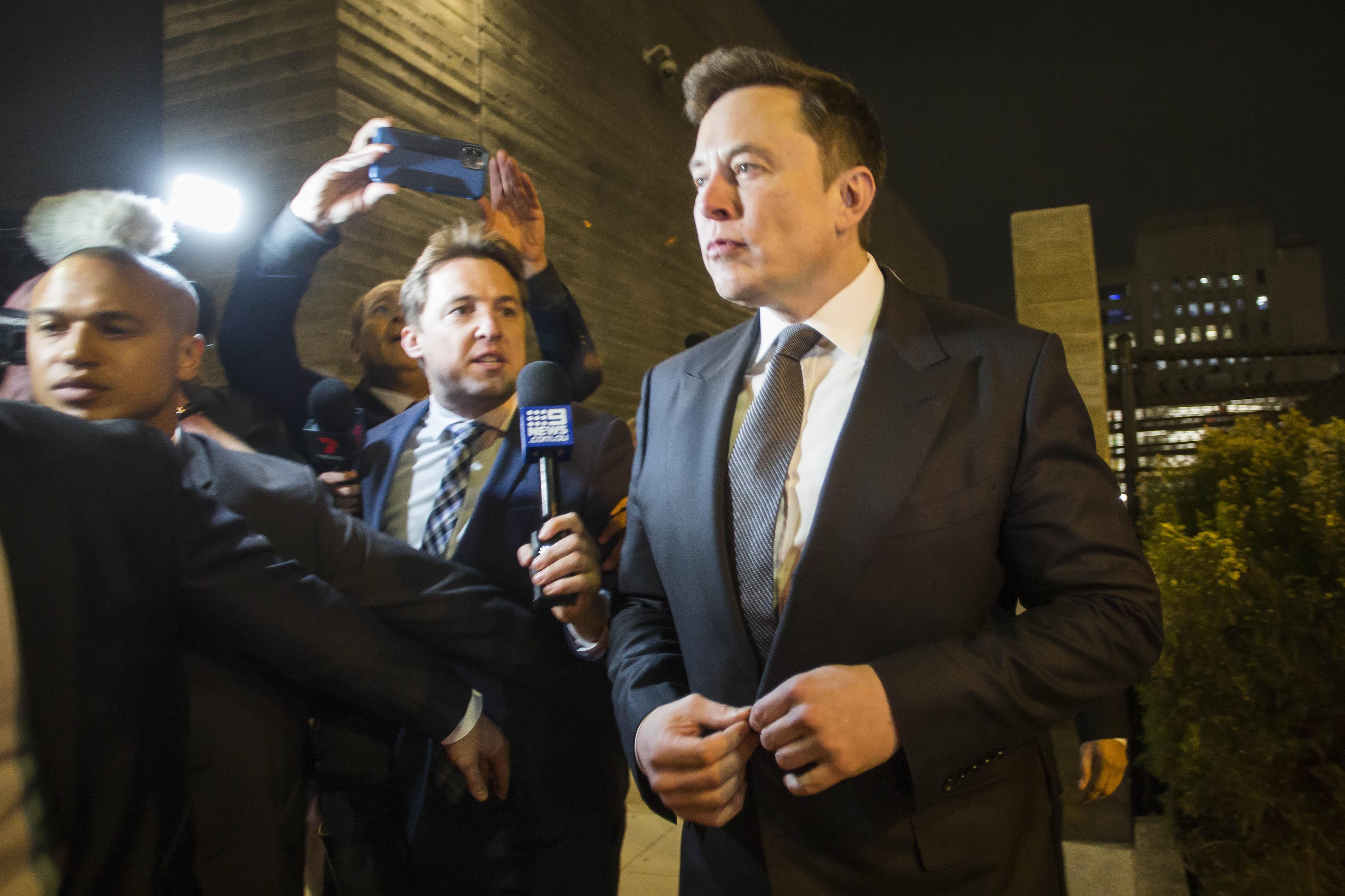 Elon Musk surrounded by media as he leaves court.