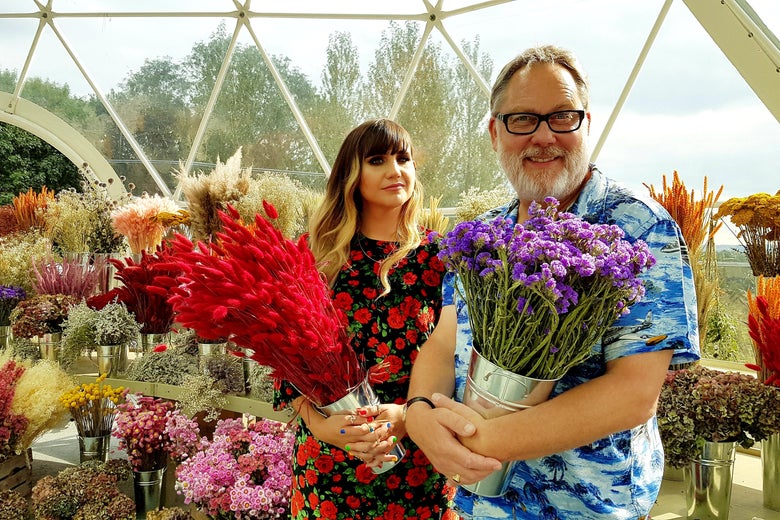 The hosts of The Big Flower Fight, surrounded by flowers.