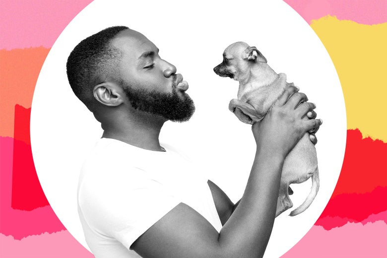 A man holds up a small dog and makes a kissing face.