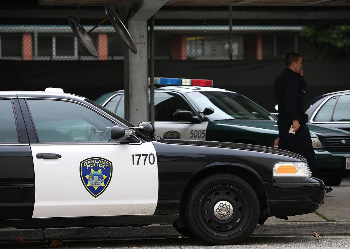 An Oakland Police officer walks by patrol cars at the Oakland Police headquarters on December 6, 2012 in Oakland, California. 
