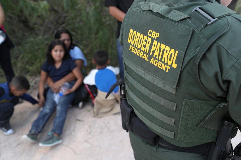 Central American asylum seekers wait as U.S. Border Patrol agents take them into custody on June 12, 2018 near McAllen, Texas. 