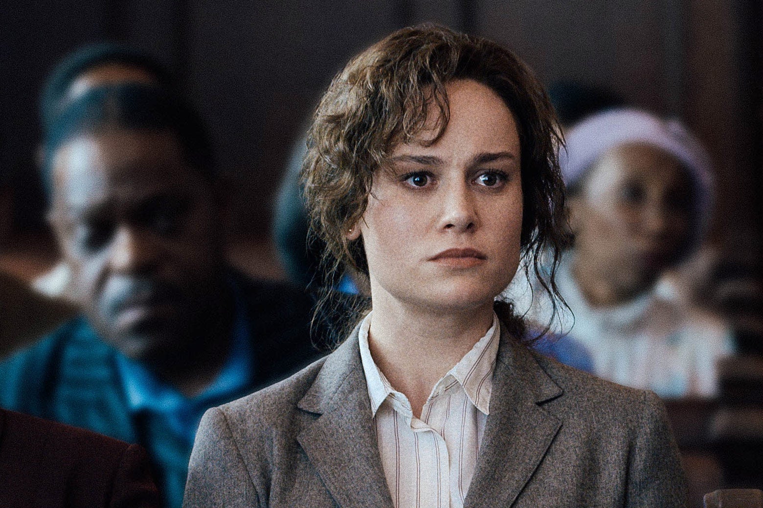 Brie Larson staring intensely with curls of hair dripping down her face