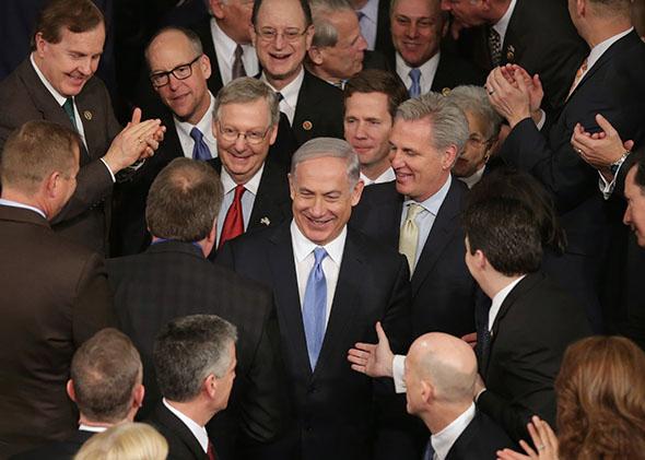 Israeli Prime Minister Benjamin Netanyahu is greeted by members of Congress as he arrives to speak during a joint meeting of the United States Congress.