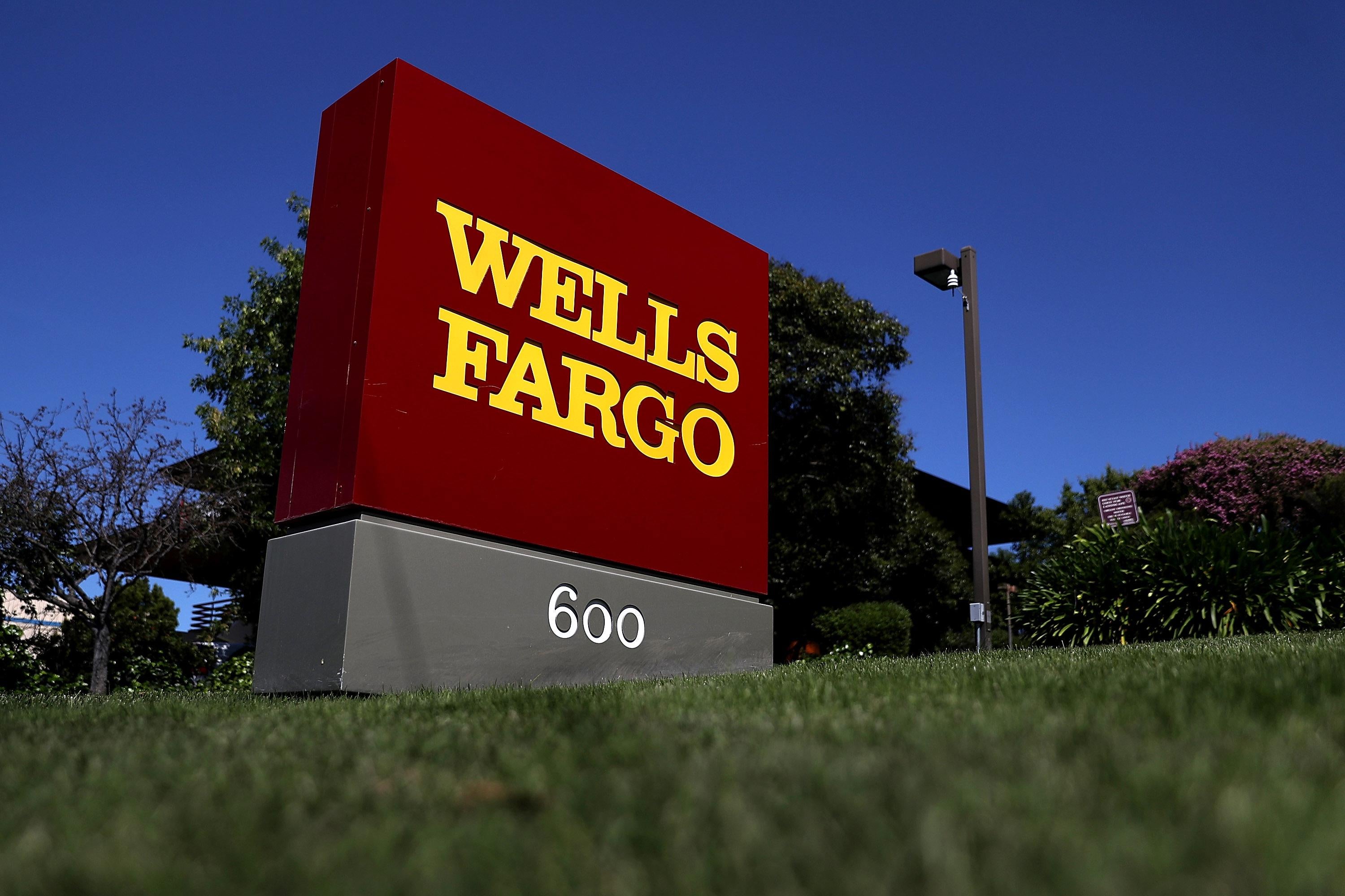 Sign displaying Wells Fargo logo outside the company's office.