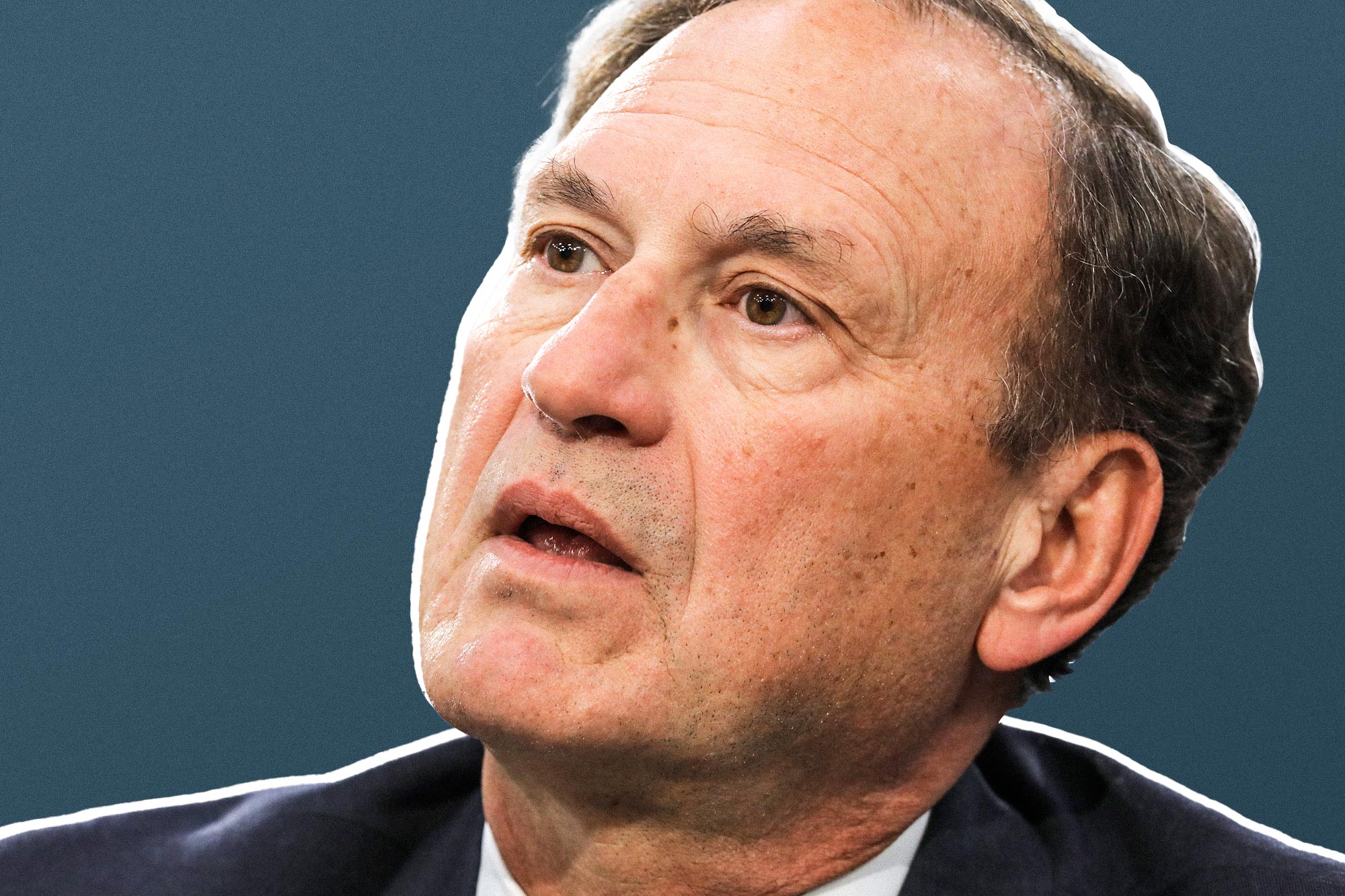 Samuel Alito in front of blue background