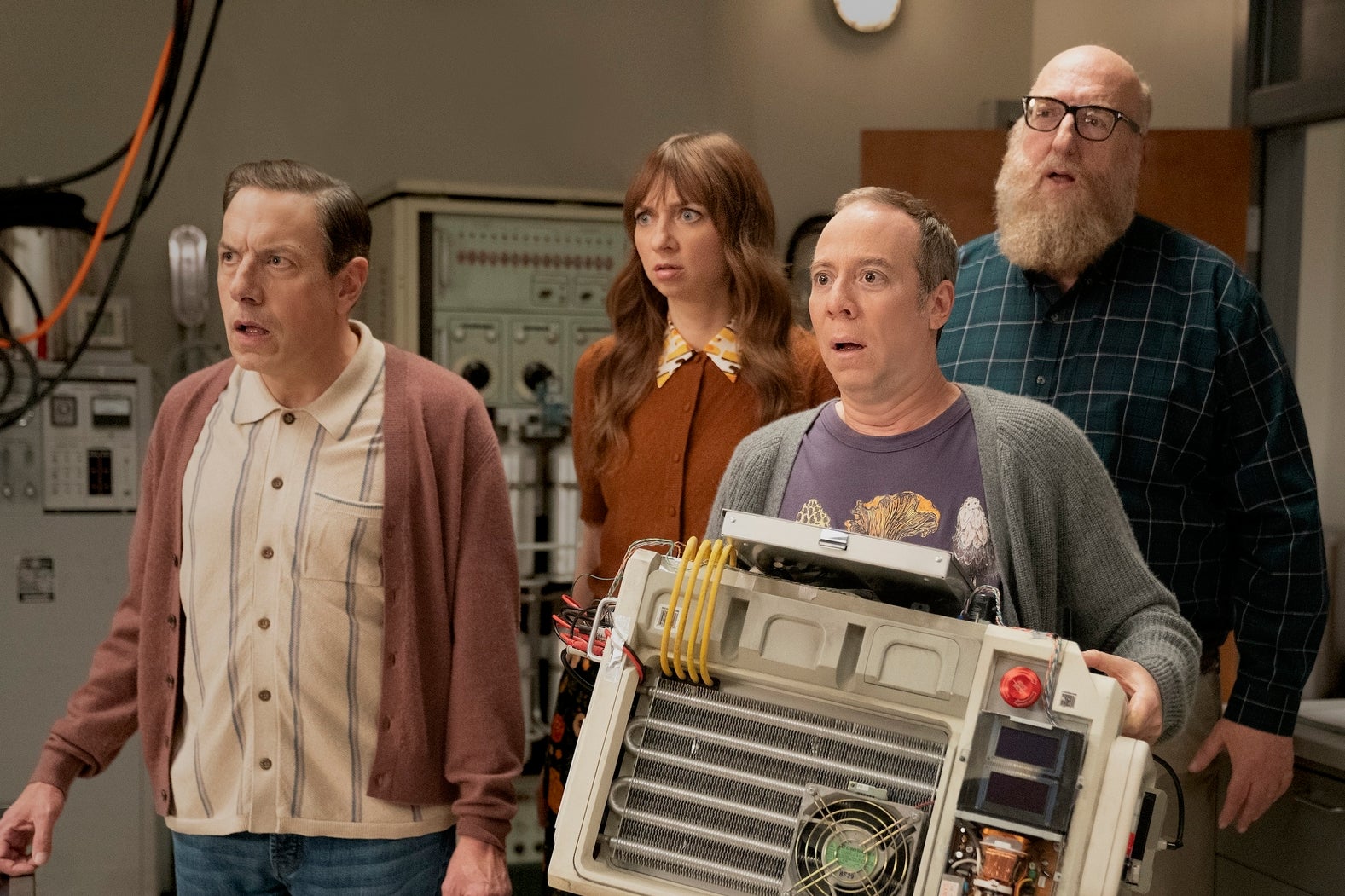 Stuart and friends holding a computer-like machine.