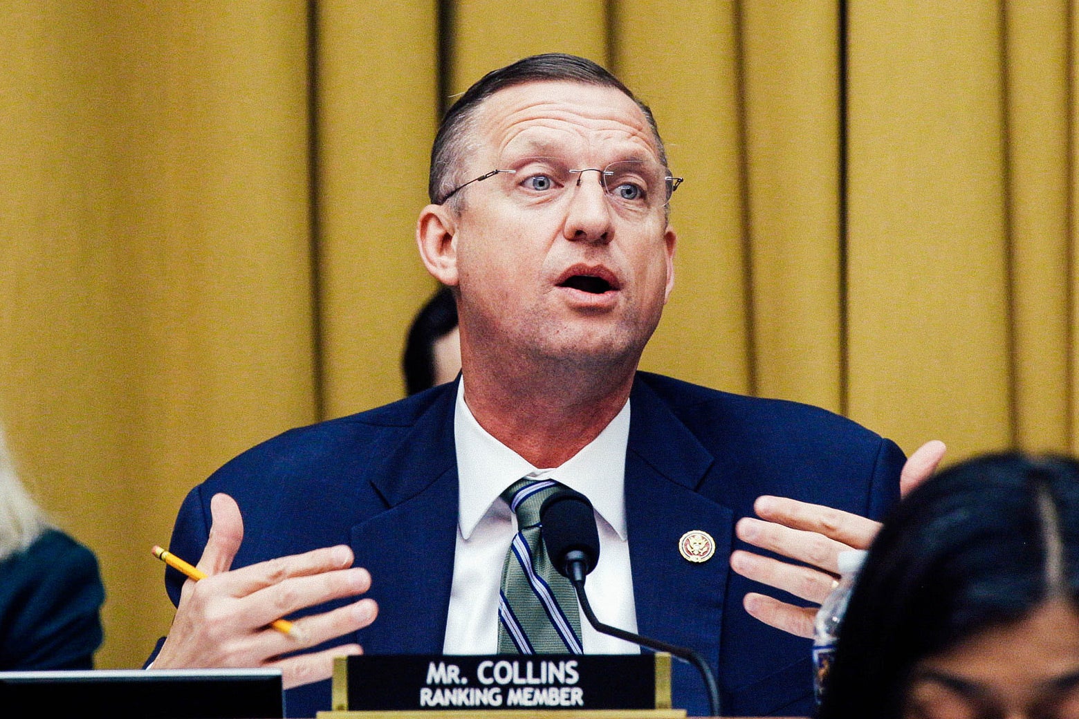 Doug Collins behind a name tag that says Mr. Collins, ranking member.