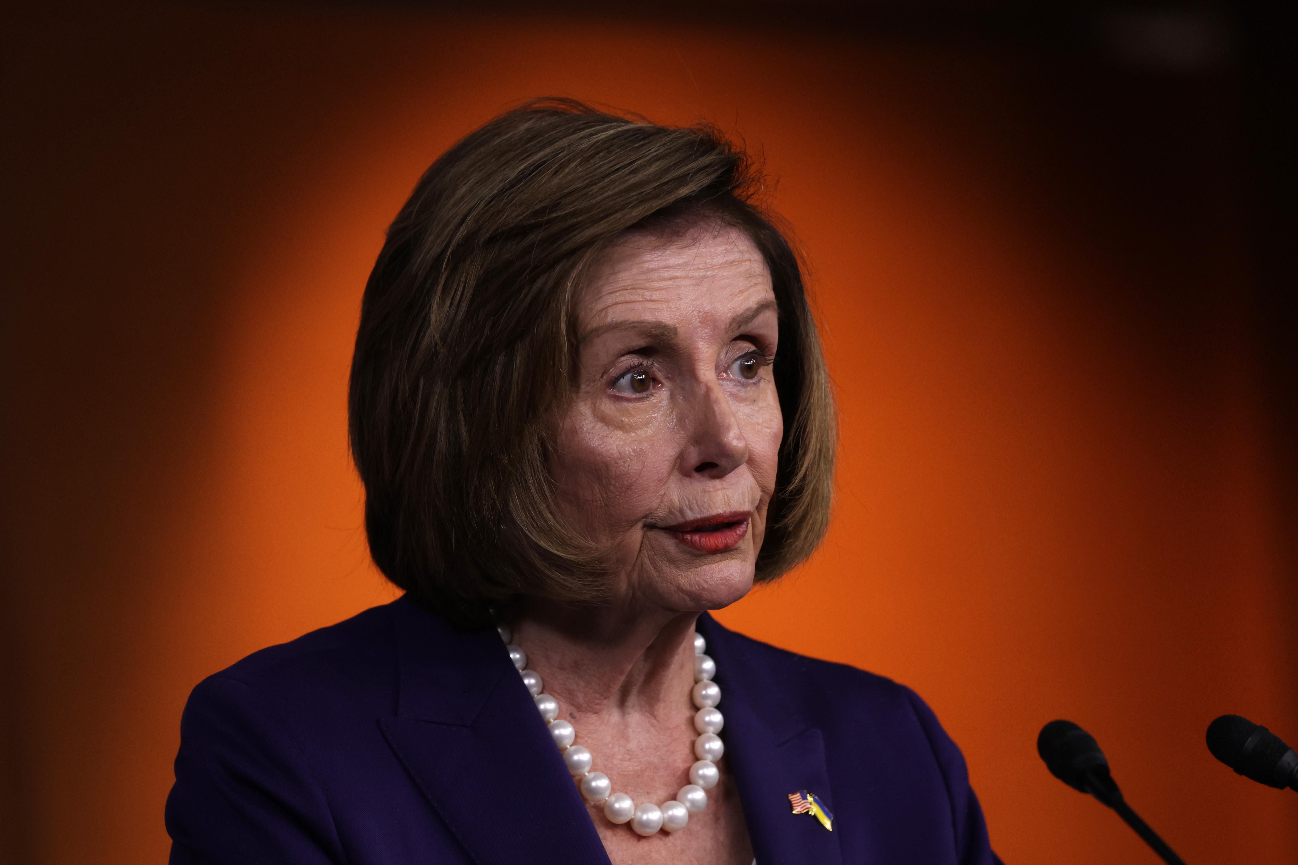 Nancy Pelosi in a purple suit.